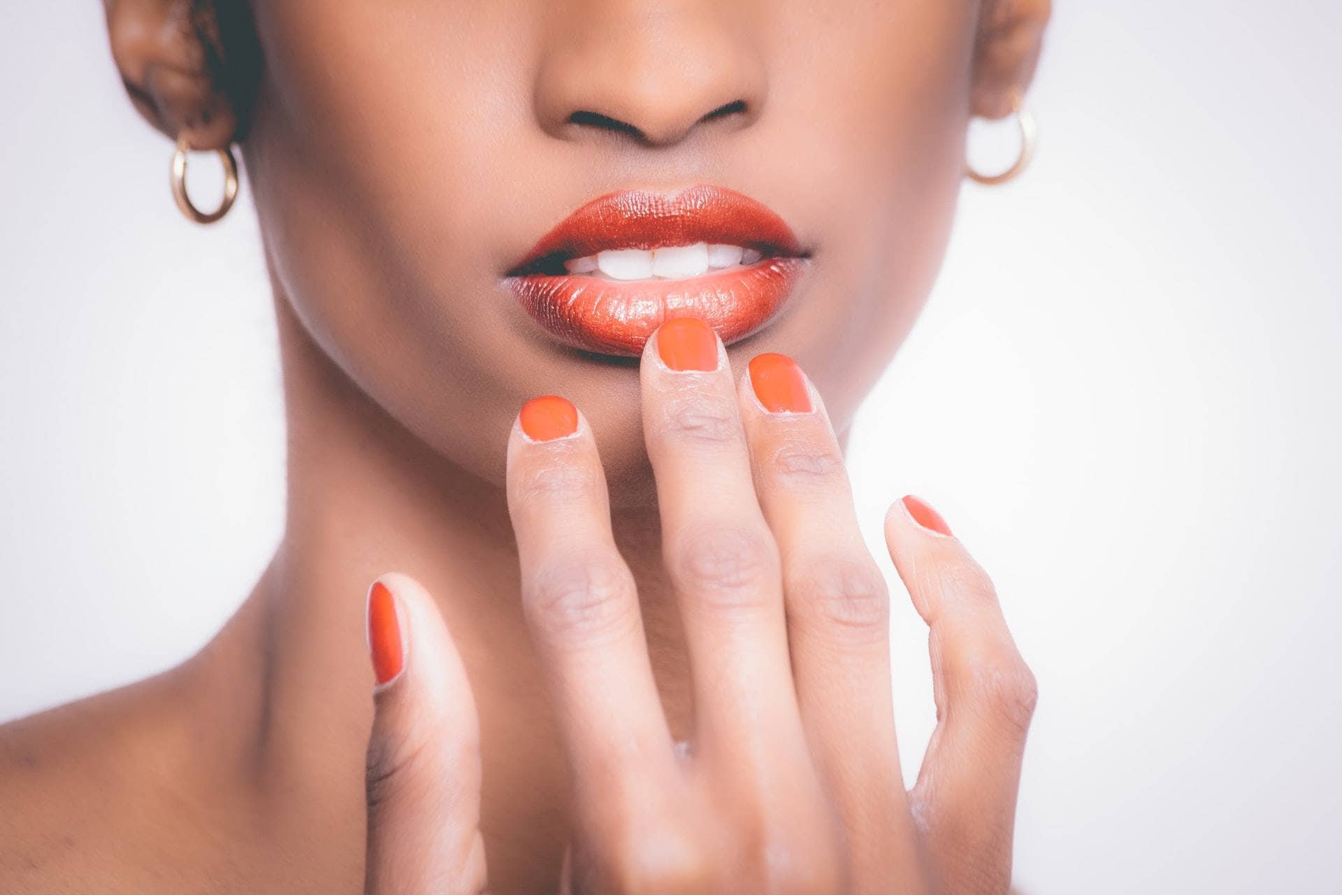 woman touching lip orange